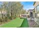 Lush backyard featuring artificial turf, mature landscaping, and desert vegetation at 2170 Monte Bianco Pl, Henderson, NV 89044