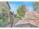 Beautiful backyard featuring mature desert landscaping, a cozy seating area, and paver stones at 2170 Monte Bianco Pl, Henderson, NV 89044