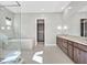 Bright bathroom featuring a glass shower, soaking tub, dual sink vanity, and walk-in closet at 2170 Monte Bianco Pl, Henderson, NV 89044