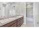 This modern bathroom features a double sink vanity, a large mirror, and shower/tub at 2170 Monte Bianco Pl, Henderson, NV 89044