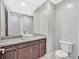 Powder room boasts a modern vanity with stylish sink and fixture, and a decorative mirror at 2170 Monte Bianco Pl, Henderson, NV 89044