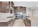 Modern kitchen with stainless steel appliances, dark wood cabinets, and a large island at 2170 Monte Bianco Pl, Henderson, NV 89044