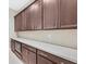 Kitchen featuring dark wood cabinetry, stainless steel appliances, and a long countertop space at 2170 Monte Bianco Pl, Henderson, NV 89044