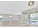 Spacious living area featuring access to the outdoor patio, recessed lighting, and tile flooring at 2170 Monte Bianco Pl, Henderson, NV 89044