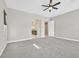 Spacious main bedroom features neutral walls, plush gray carpet, ceiling fan, and ensuite bathroom access at 2170 Monte Bianco Pl, Henderson, NV 89044