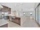 Modern open floor plan seamlessly integrating the kitchen, dining, and living areas with tiled floors at 2170 Monte Bianco Pl, Henderson, NV 89044