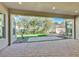 A covered patio offers beautiful views of the backyard, featuring a brick patio and desert landscaping at 2170 Monte Bianco Pl, Henderson, NV 89044