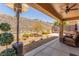 Inviting back patio area with comfortable seating and a beautiful desert landscape at 2398 Jada Dr, Henderson, NV 89044