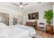 Relaxing bedroom with hardwood floors, ceiling fan, a TV and a decorative bureau at 2398 Jada Dr, Henderson, NV 89044