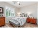 Cozy bedroom with bench seating, hardwood floors, plantation shutters, and ceiling fan at 2398 Jada Dr, Henderson, NV 89044