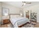 Bright bedroom features a ceiling fan, wood floors and an ensuite bathroom entrance at 2398 Jada Dr, Henderson, NV 89044