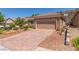 Charming single-story home featuring a professionally landscaped yard and brick paved driveway at 2398 Jada Dr, Henderson, NV 89044