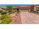 Charming single-story home featuring a beautifully landscaped yard and brick paved driveway at 2398 Jada Dr, Henderson, NV 89044