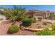 Inviting home features a well-maintained yard with desert landscaping and stone accents at 2398 Jada Dr, Henderson, NV 89044