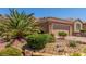 Inviting home features a well-maintained yard with desert landscaping and stone accents at 2398 Jada Dr, Henderson, NV 89044