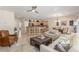 Bright living room and kitchen area featuring tile floors, breakfast bar seating, and modern lighting at 2398 Jada Dr, Henderson, NV 89044
