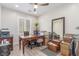 Bright home office with shuttered windows, hardwood floors, large mirror, and ample storage at 2398 Jada Dr, Henderson, NV 89044