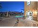 Inviting backyard with a rock-accented pool, patio seating, and an arched walkway against a picturesque mountain backdrop at 2571 Red Springs Dr, Las Vegas, NV 89135