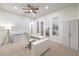 Large bedroom with neutral carpet, white walls, a ceiling fan, and outdoor patio access at 2571 Red Springs Dr, Las Vegas, NV 89135