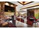 Elegant dining area with a stone fireplace, TV and large windows offering stunning views, creating a cozy and luxurious ambiance at 2571 Red Springs Dr, Las Vegas, NV 89135