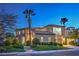 Elegant two-story home with mature landscaping, stucco exterior, and a private balcony at 2571 Red Springs Dr, Las Vegas, NV 89135