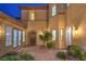 Elegant home exterior with paver courtyard, mature tree, and designer lighting at 2571 Red Springs Dr, Las Vegas, NV 89135