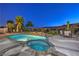 Sparkling pool and spa with lush landscaping and mountain views at twilight at 2571 Red Springs Dr, Las Vegas, NV 89135