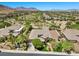 Aerial view of a suburban neighborhood featuring a golf course and mountain views at 3048 Red Arrow Dr, Las Vegas, NV 89135