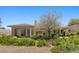Well landscaped backyard with grass and desert landscaping at 3048 Red Arrow Dr, Las Vegas, NV 89135