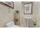 Decorated powder room with white toilet, pedestal sink, and wallpaper at 3048 Red Arrow Dr, Las Vegas, NV 89135