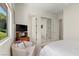 Bedroom showcasing white walls, a comfortable chair, and an abundance of natural light at 3048 Red Arrow Dr, Las Vegas, NV 89135