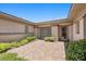 Private courtyard entrance featuring tiled flooring and lush green landscaping at 3048 Red Arrow Dr, Las Vegas, NV 89135