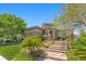 Stunning single-story home with stone accents, manicured lawn, and inviting landscaped entrance at 3048 Red Arrow Dr, Las Vegas, NV 89135