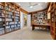 Large home library with filled bookshelves and built-in desk at 3048 Red Arrow Dr, Las Vegas, NV 89135