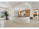 Open-concept living room featuring an elegant curved island, a chandelier, and an abundance of natural light at 3048 Red Arrow Dr, Las Vegas, NV 89135