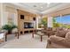 Cozy living room showcases a built-in entertainment unit, comfortable seating, and serene backyard views at 3048 Red Arrow Dr, Las Vegas, NV 89135