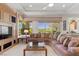 Spacious living room featuring a plush sectional sofa, built-in media center, and scenic outdoor views at 3048 Red Arrow Dr, Las Vegas, NV 89135