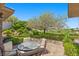 Inviting outdoor patio with beautiful landscaping and a table with four chairs, perfect for enjoying the view at 3048 Red Arrow Dr, Las Vegas, NV 89135