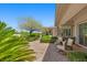 Back patio features covered seating and lush landscaping at 3048 Red Arrow Dr, Las Vegas, NV 89135