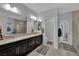 Bright bathroom with double sinks, framed mirrors and a walk-in shower, creating a spa-like experience at 333 Mandarin Hill Ln, Henderson, NV 89012
