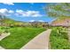 Beautiful community park with a well-manicured lawn, scenic walking path, and lush landscaping at 333 Mandarin Hill Ln, Henderson, NV 89012