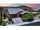 Beautiful home featuring a three-car garage, tiled roof, and lush landscaping at 333 Mandarin Hill Ln, Henderson, NV 89012