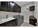 Modern laundry room with dark cabinetry and stainless steel appliances at 333 Mandarin Hill Ln, Henderson, NV 89012