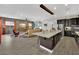 Open floor plan featuring a kitchen island, living room and brick accent wall provides the perfect space for living and entertaining at 333 Mandarin Hill Ln, Henderson, NV 89012
