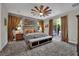The main bedroom features a striking accent wall, slider to the backyard, and a ceiling fan for optimal comfort at 333 Mandarin Hill Ln, Henderson, NV 89012