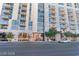 Modern apartment building featuring multiple balconies and expansive windows, with a well-kept street at 353 E Bonneville Ave # 711, Las Vegas, NV 89101