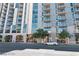 Exterior view of modern apartment building featuring large windows and balconies on a sunny day at 353 E Bonneville Ave # 711, Las Vegas, NV 89101
