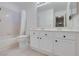 Bright bathroom featuring a white vanity, mirror, and tub with shower at 364 Dooley Dr, Henderson, NV 89015