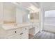 Bathroom with double sinks, laminate flooring, and large mirror at 364 Dooley Dr, Henderson, NV 89015