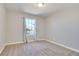 This bedroom offers neutral carpeting, paint, and baseboards with a bright window view at 364 Dooley Dr, Henderson, NV 89015